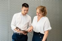 Man and woman exchanging details during business transaction.